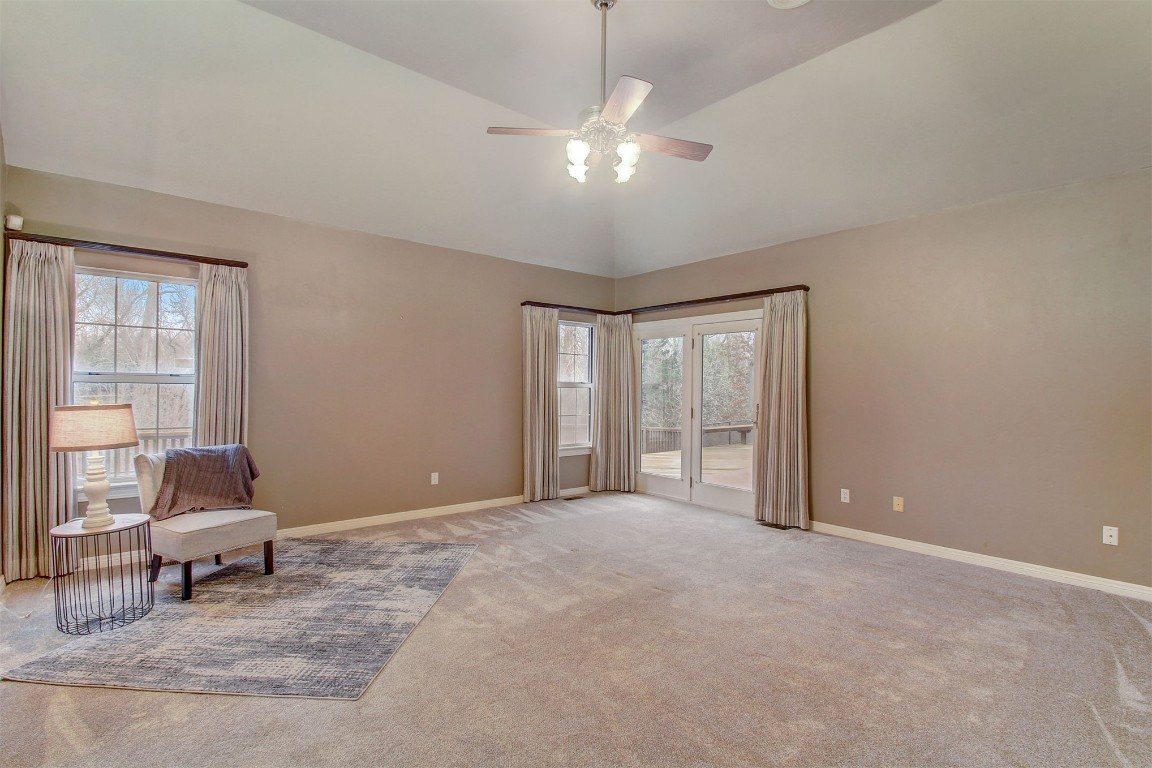 695 Kingsgate Road, Yukon, OK 73099 living area with ceiling fan, light colored carpet, and high vaulted ceiling