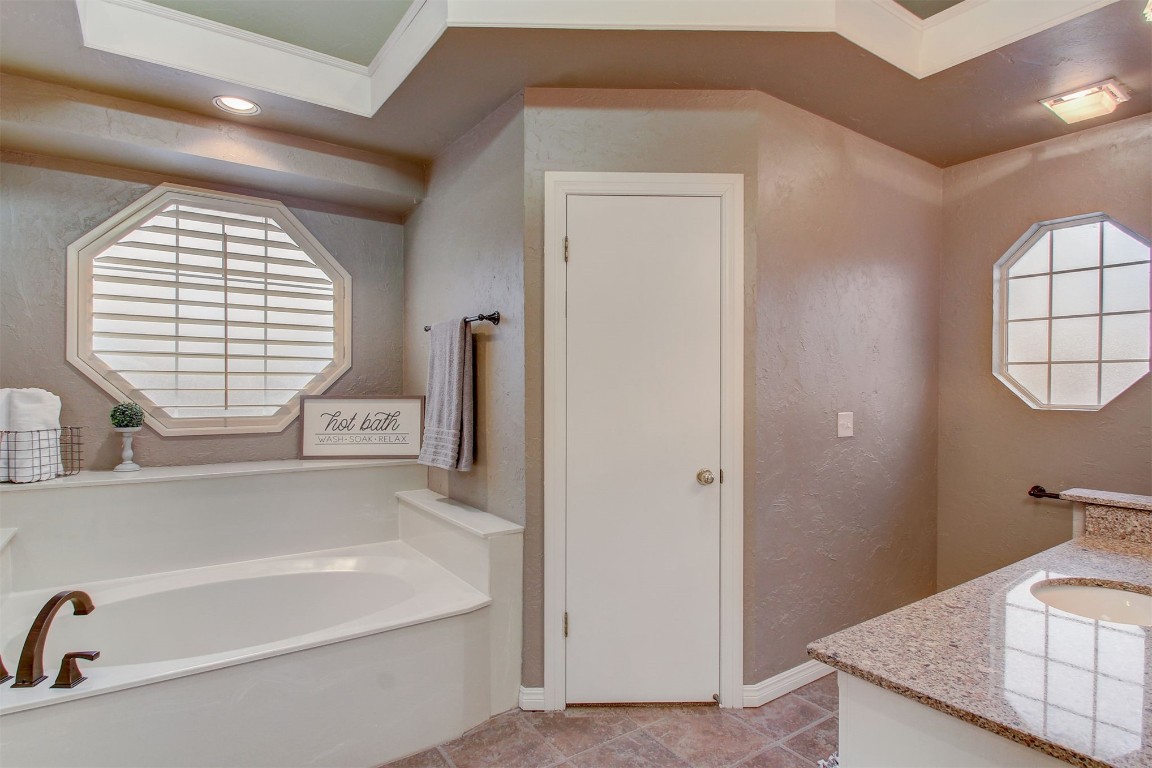 695 Kingsgate Road, Yukon, OK 73099 bathroom with vanity, tile flooring, and a washtub