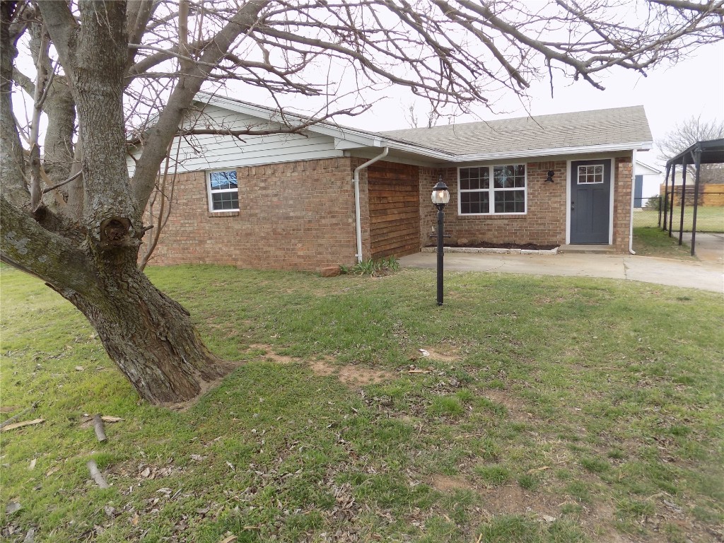 2706 CS 2831, Chickasha, OK 73018 ranch-style house featuring a carport and a front lawn