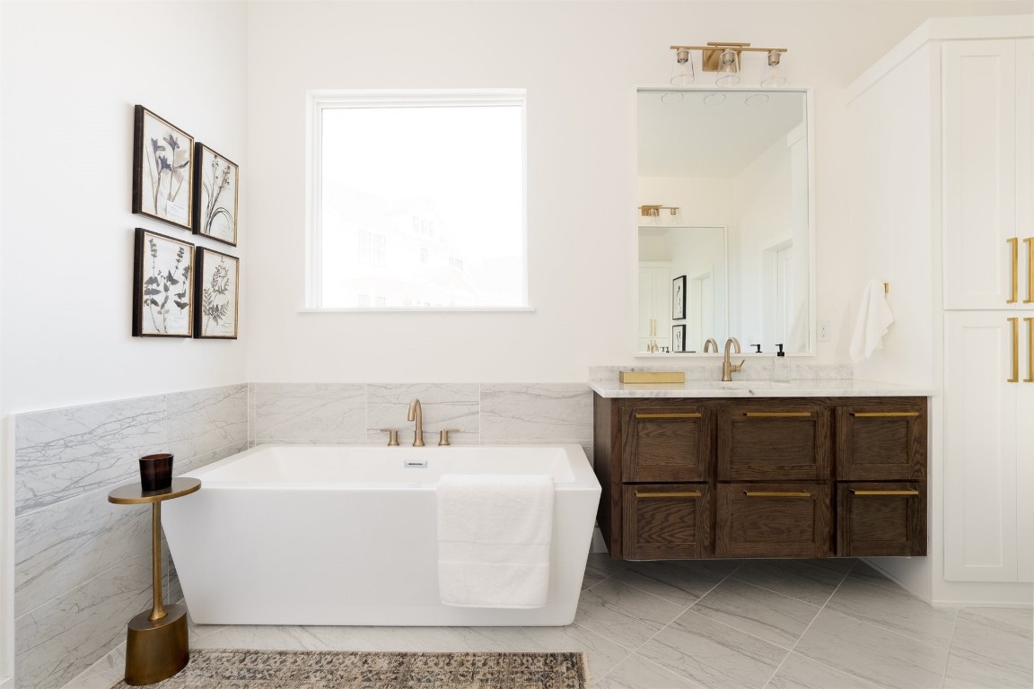 521 Old Creek Road, Edmond, OK 73034 bathroom with vanity, tile flooring, and a bathing tub