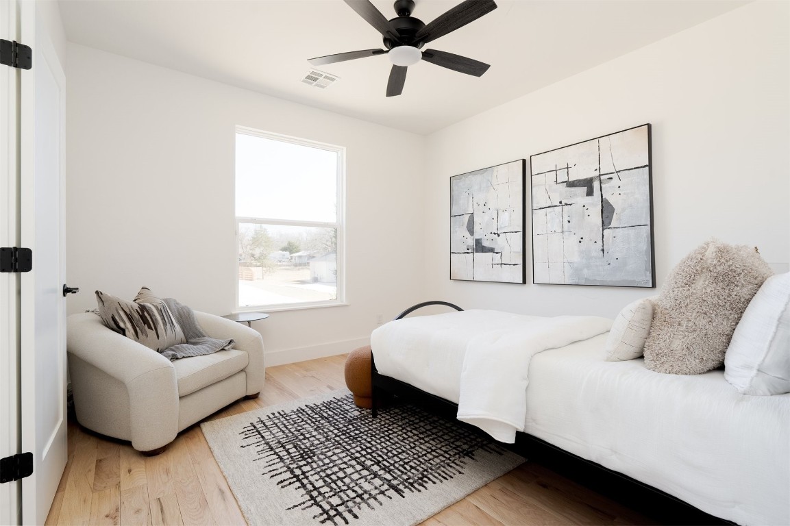 521 Old Creek Road, Edmond, OK 73034 bedroom featuring ceiling fan and light hardwood / wood-style flooring