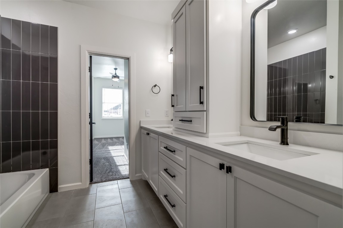 10716 Swift Circle, Yukon, OK 73099 bathroom featuring tile flooring and dual bowl vanity