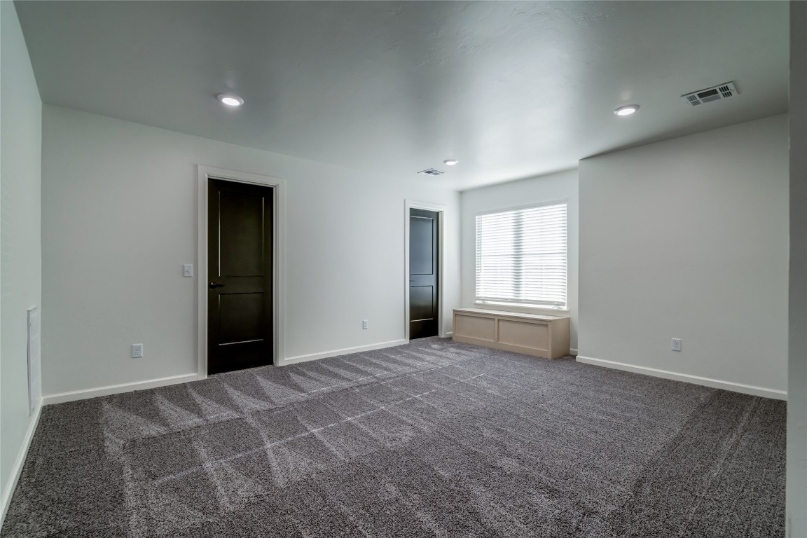 10716 Swift Circle, Yukon, OK 73099 unfurnished bedroom with dark carpet