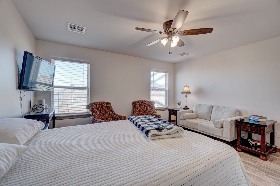 5851 Starry Night, Piedmont, OK 73078 bedroom featuring multiple windows, ceiling fan, and light hardwood / wood-style floors