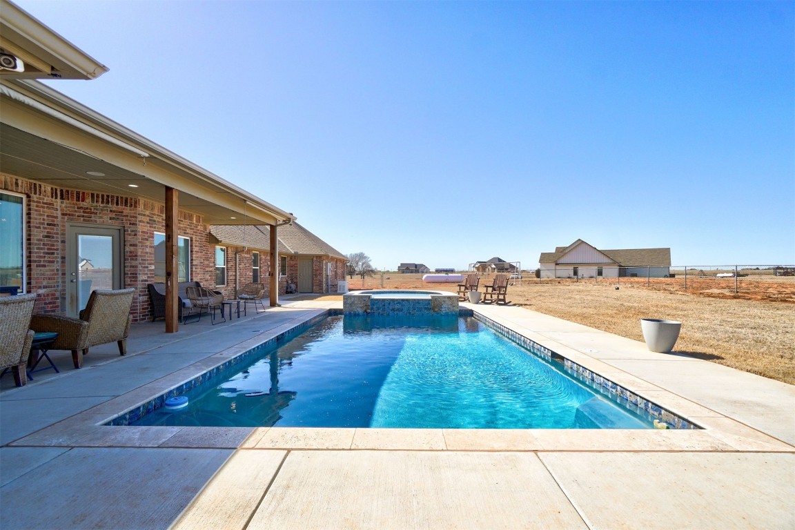 5851 Starry Night, Piedmont, OK 73078 view of swimming pool featuring a patio and an in ground hot tub