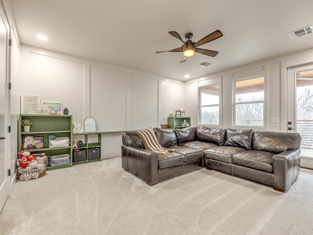 14504 Chambord Drive, Yukon, OK 73099 carpeted living room featuring ceiling fan
