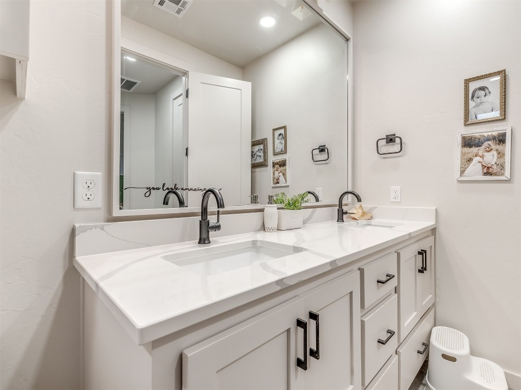 14504 Chambord Drive, Yukon, OK 73099 bathroom featuring double sink and large vanity