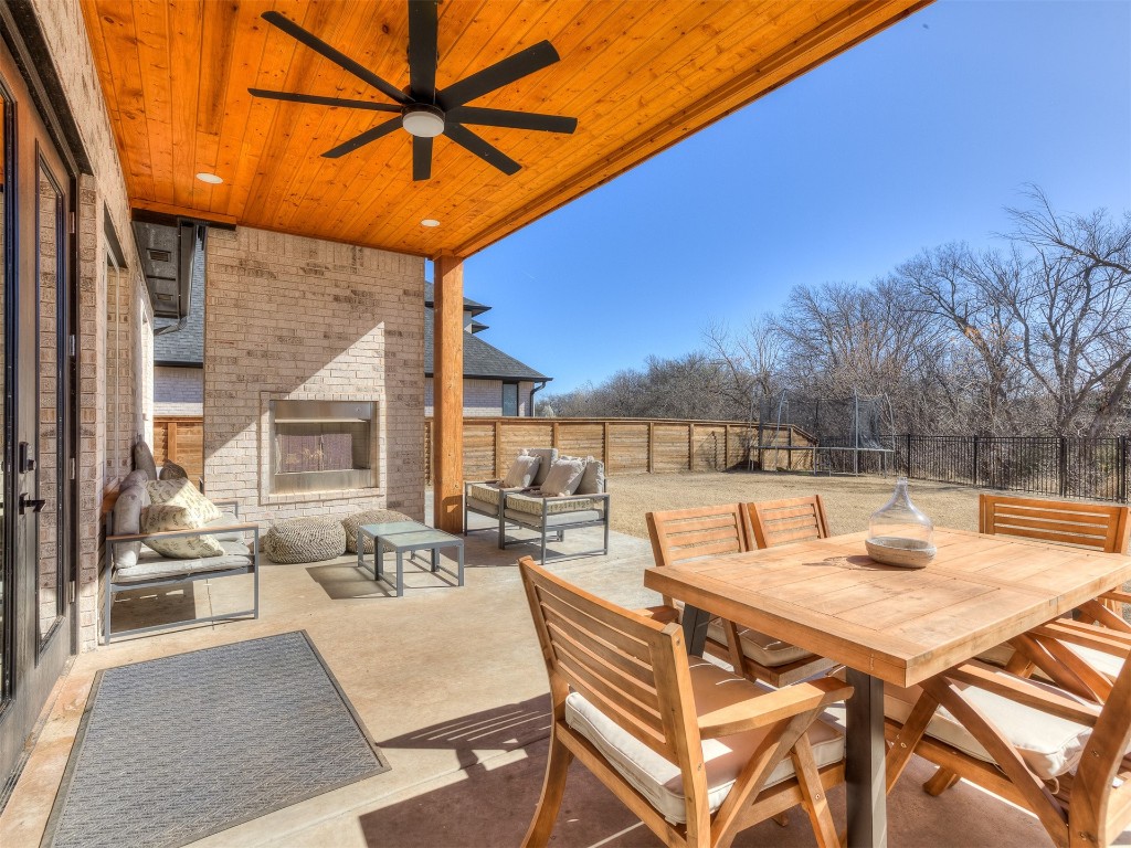 14504 Chambord Drive, Yukon, OK 73099 view of patio / terrace featuring ceiling fan and an outdoor living space with a fireplace