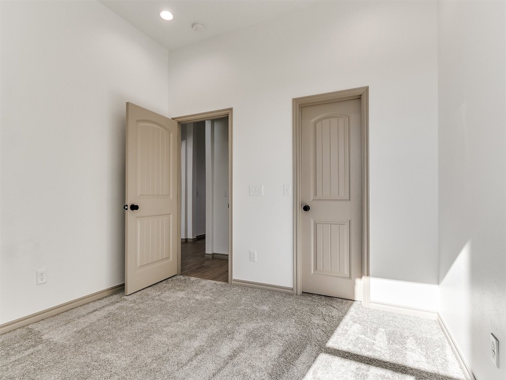 16755 Pondview Lane, Yukon, OK 73099 unfurnished bedroom featuring light carpet