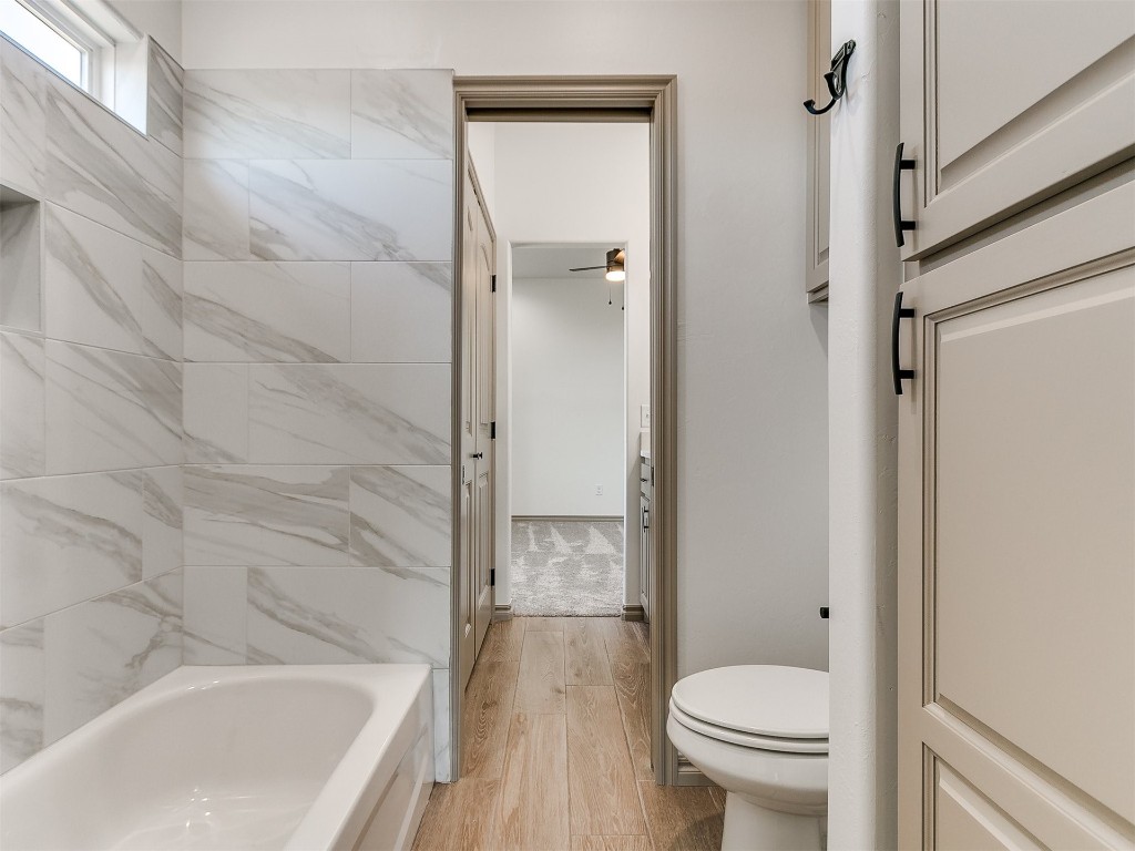 16755 Pondview Lane, Yukon, OK 73099 bathroom with hardwood / wood-style flooring and toilet