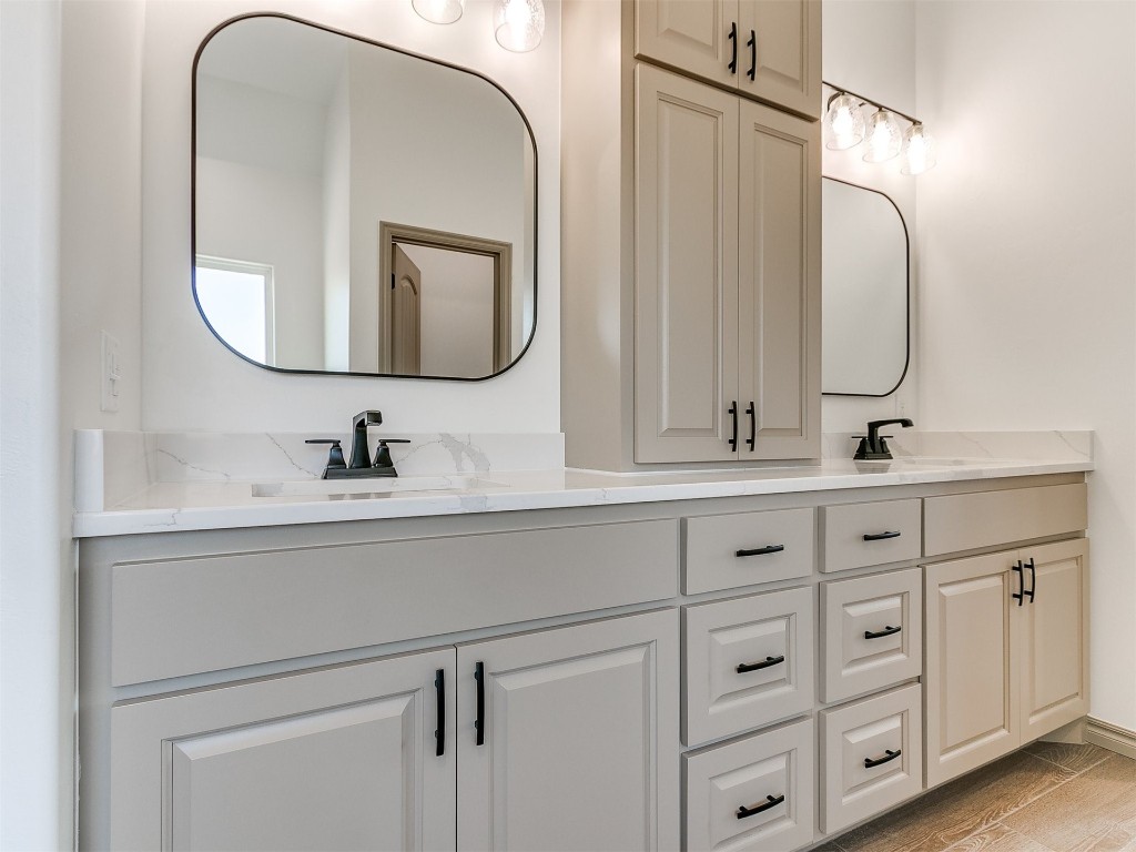 16755 Pondview Lane, Yukon, OK 73099 bathroom featuring wood-type flooring, double sink, and oversized vanity