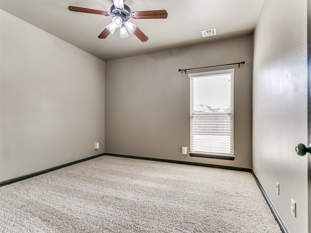 4708 NW 153rd Street, Edmond, OK 73013 unfurnished bedroom featuring light tile flooring and ceiling fan