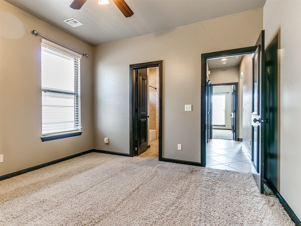 4708 NW 153rd Street, Edmond, OK 73013 unfurnished room featuring ornamental molding, light carpet, ceiling fan, and baseboard heating