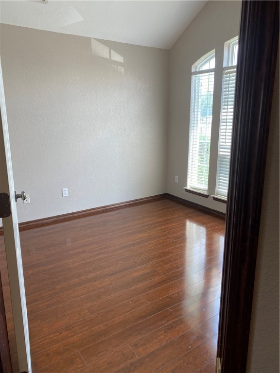 717 SW 161st Street, Oklahoma City, OK 73170 empty room with dark hardwood / wood-style flooring