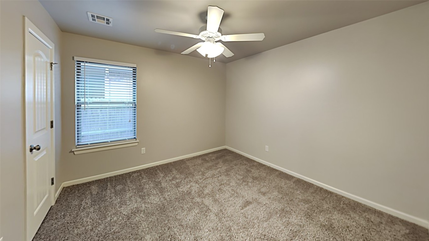 8914 Oak Valley Drive, Midwest City, OK 73110 carpeted spare room with ceiling fan
