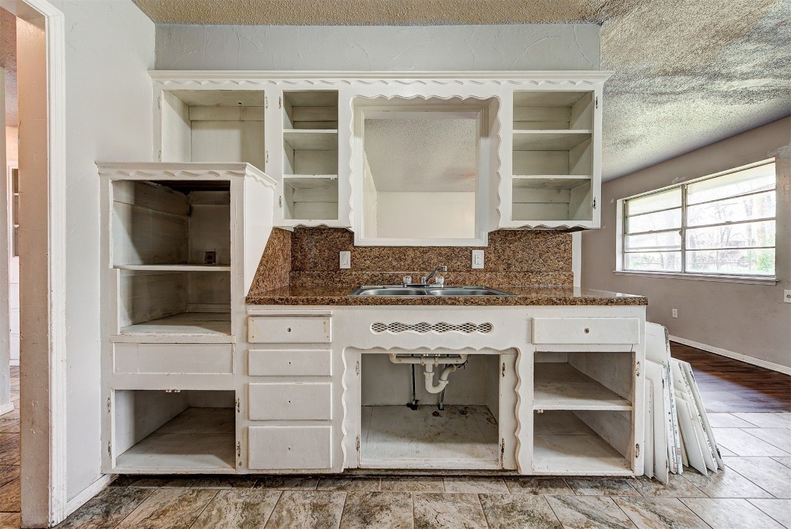 8709 N Hudson Avenue, Oklahoma City, OK 73114 kitchen with backsplash, a textured ceiling, sink, and hardwood / wood-style flooring