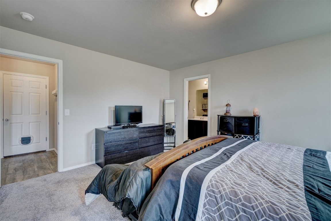 1316 Peridot Lane, Noble, OK 73068 carpeted bedroom featuring ensuite bathroom