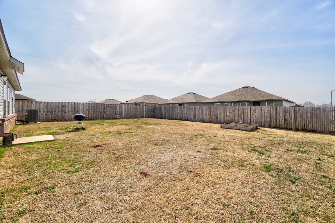 1316 Peridot Lane, Noble, OK 73068 view of yard featuring central AC unit