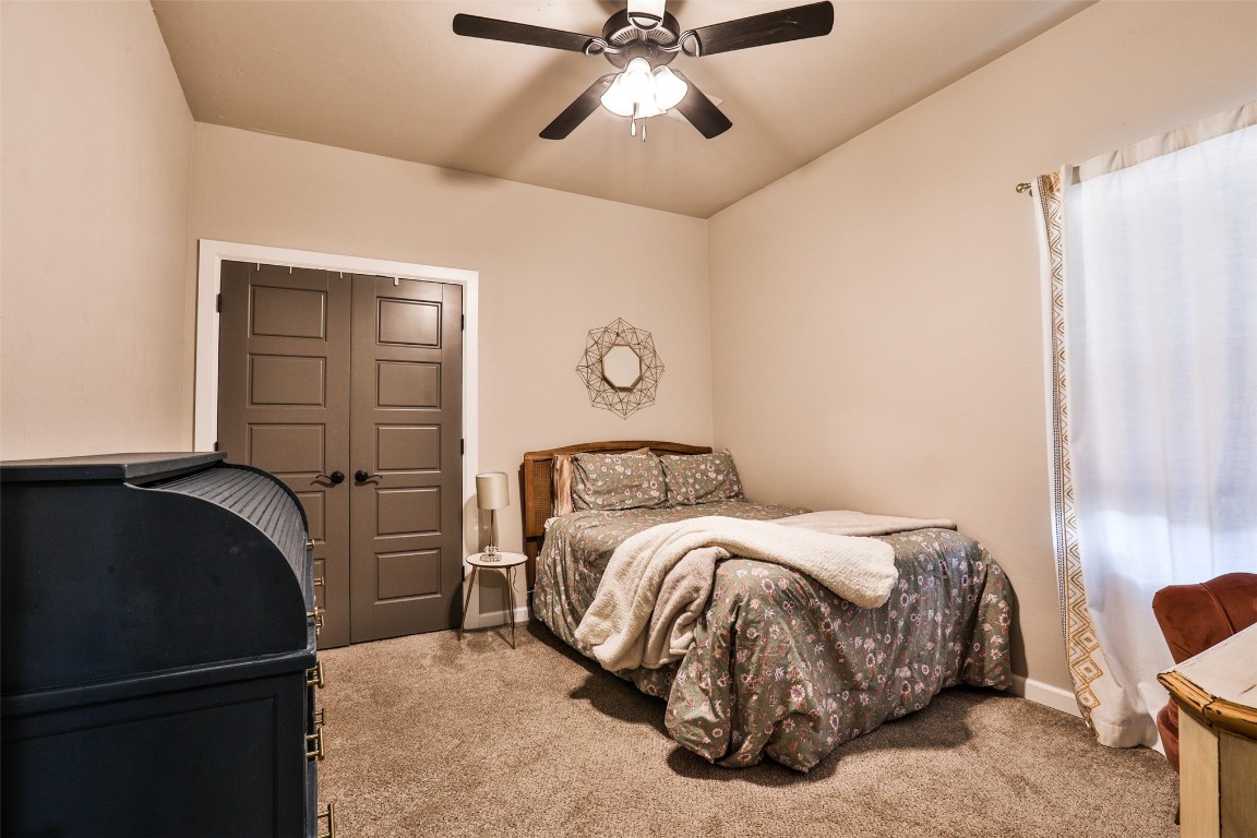 12017 SW 50th Street, Mustang, OK 73064 carpeted bedroom featuring ceiling fan