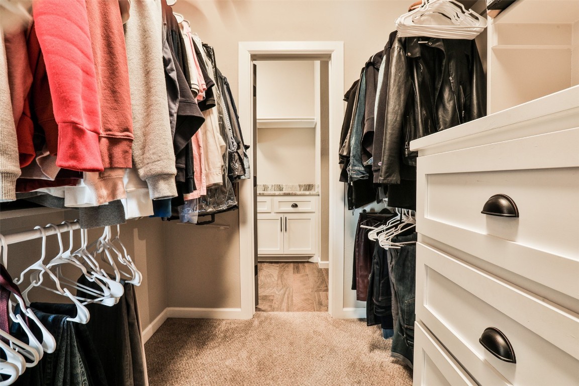 12017 SW 50th Street, Mustang, OK 73064 walk in closet featuring light colored carpet