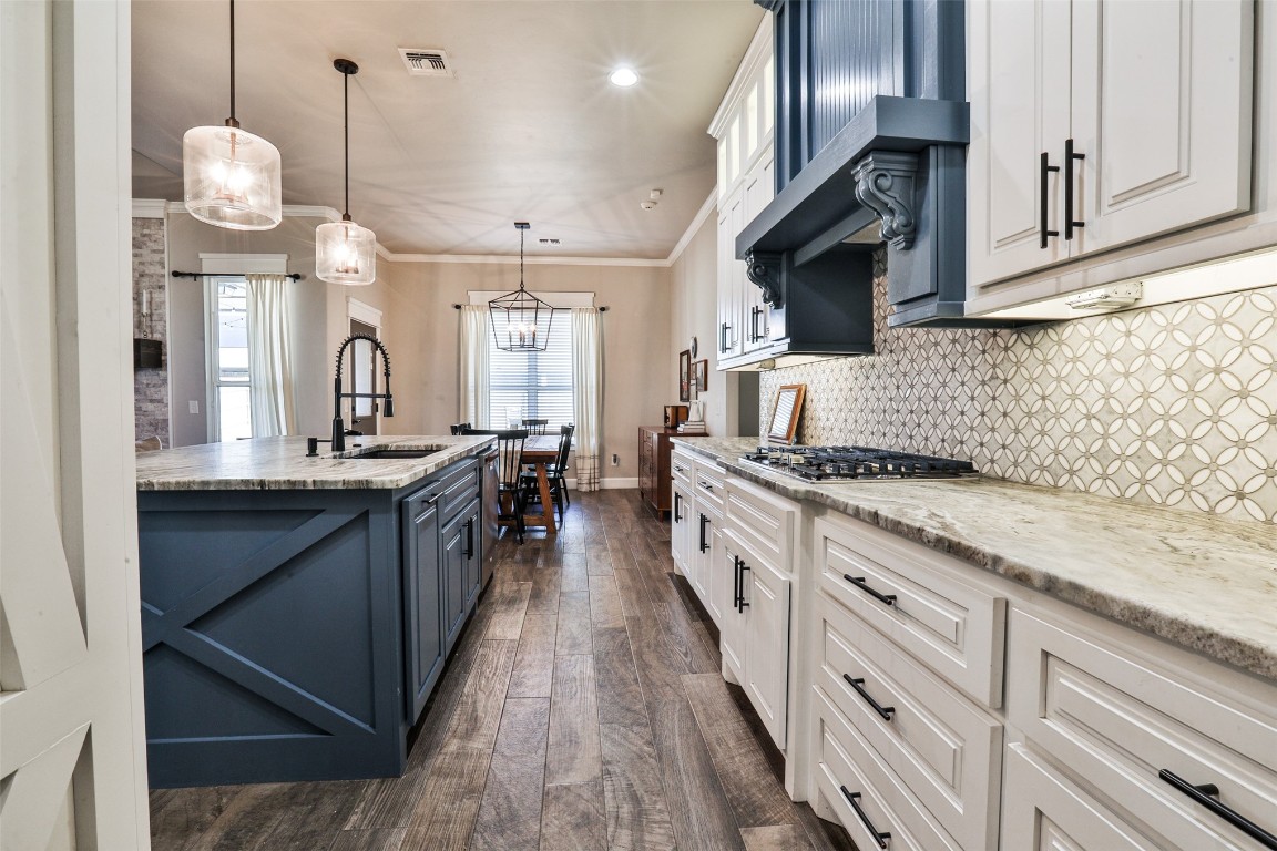 12017 SW 50th Street, Mustang, OK 73064 kitchen featuring white cabinetry, tasteful backsplash, and dark hardwood / wood-style floors