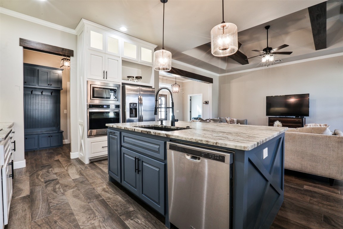 12017 SW 50th Street, Mustang, OK 73064 kitchen featuring white cabinetry, stainless steel appliances, hanging light fixtures, and ceiling fan