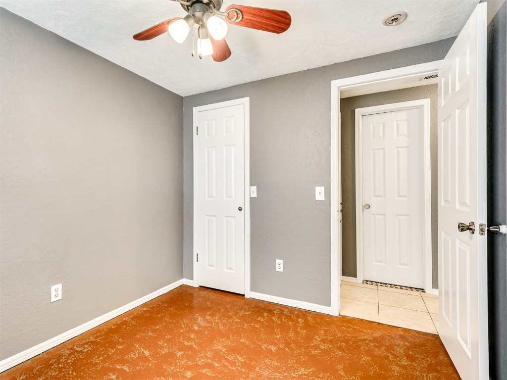 8416 NW 92nd Street, Oklahoma City, OK 73132 unfurnished bedroom featuring light tile flooring and ceiling fan
