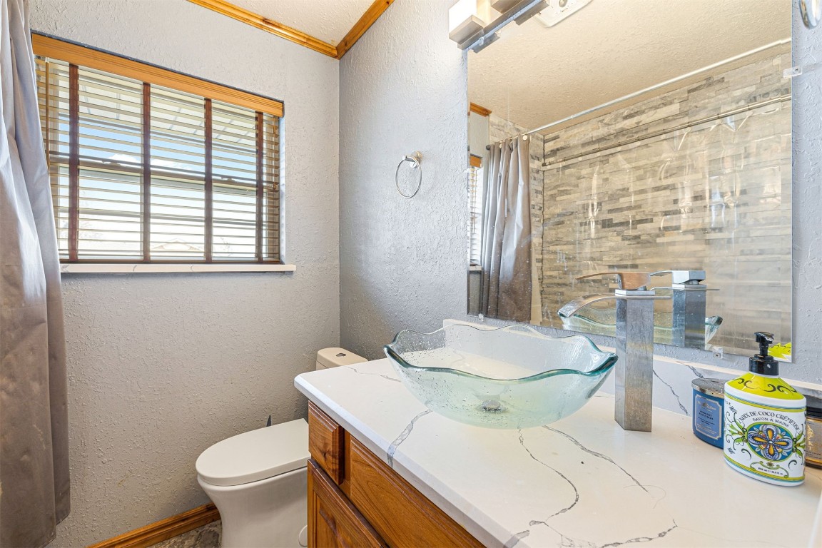 1804 NE 53rd Street, Oklahoma City, OK 73111 bathroom featuring vanity, toilet, and crown molding