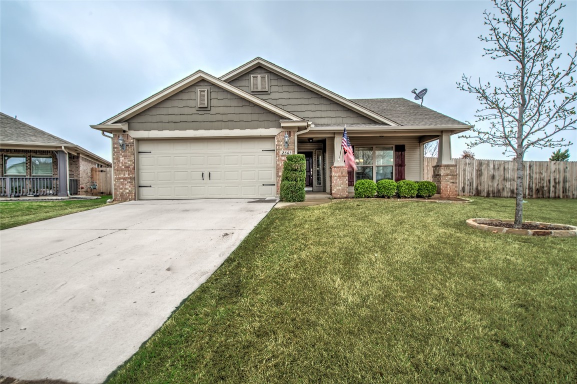 2561 NW 186th Street, Edmond, OK 73012 craftsman inspired home with a garage and a front lawn