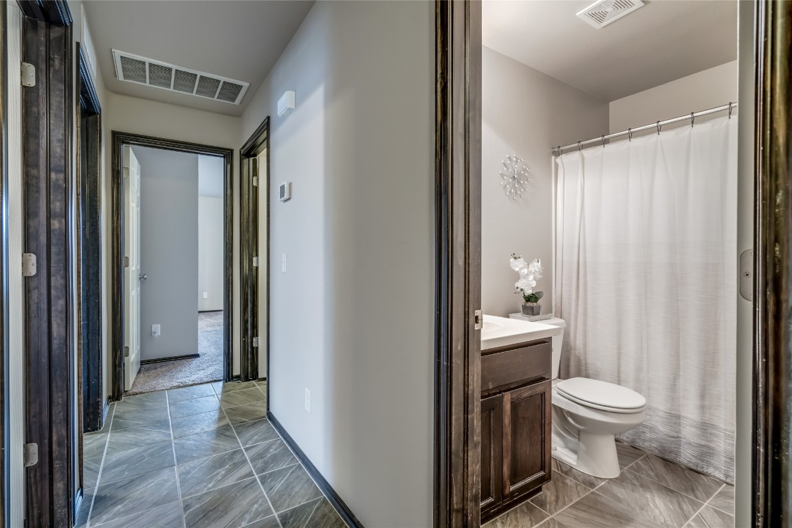 2561 NW 186th Street, Edmond, OK 73012 bathroom with vanity, toilet, and tile floors