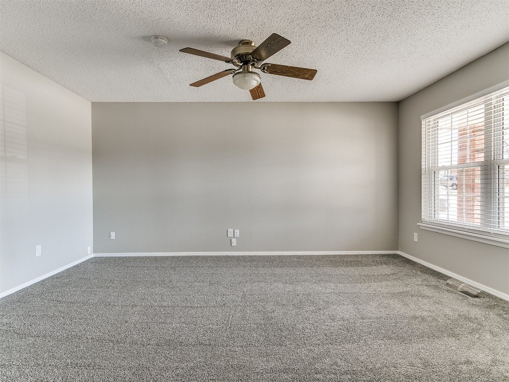 3421 Simmons Drive, Del City, OK 73115 carpeted empty room with ceiling fan and a textured ceiling
