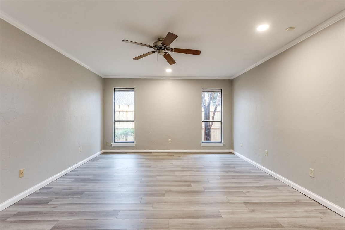 3904 Spyglass Road, Oklahoma City, OK 73120 empty room featuring ornamental molding, light hardwood / wood-style flooring, and ceiling fan