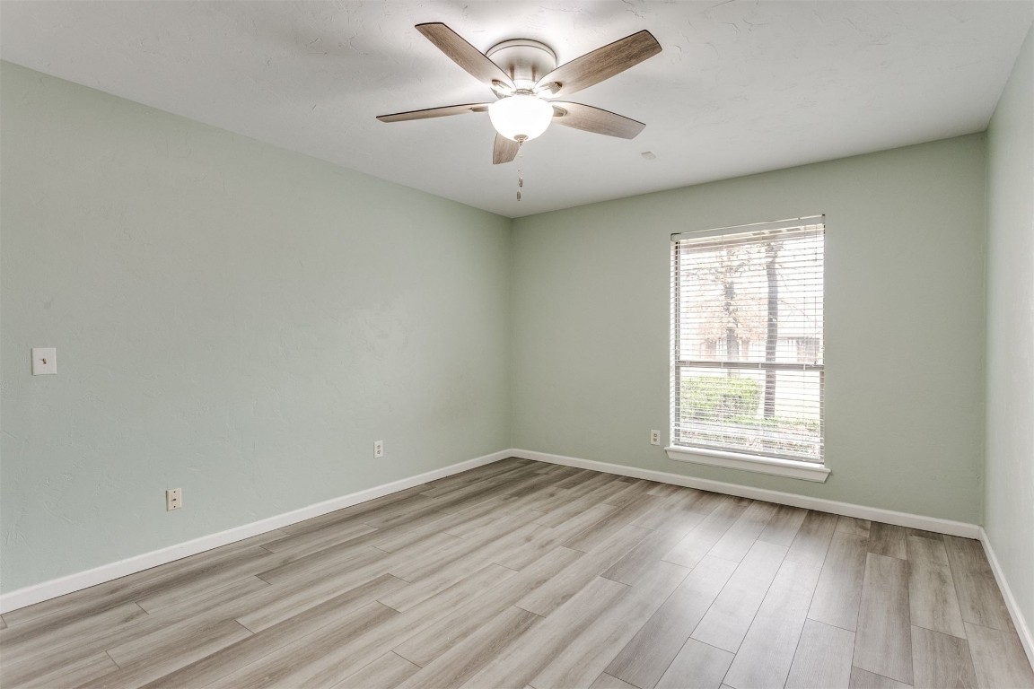 3904 Spyglass Road, Oklahoma City, OK 73120 empty room with ceiling fan and light hardwood / wood-style floors