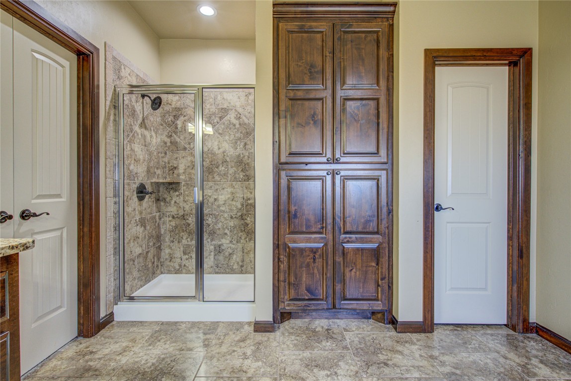 1808 Palomino Drive, Blanchard, OK 73010 bathroom featuring a shower with shower door and tile floors
