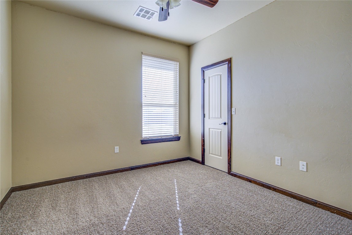 1808 Palomino Drive, Blanchard, OK 73010 spare room with light colored carpet and ceiling fan