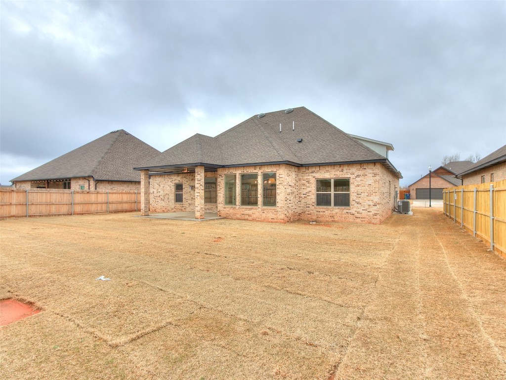 12105 SW 51st Street, Mustang, OK 73064 rear view of property with a patio area and central air condition unit