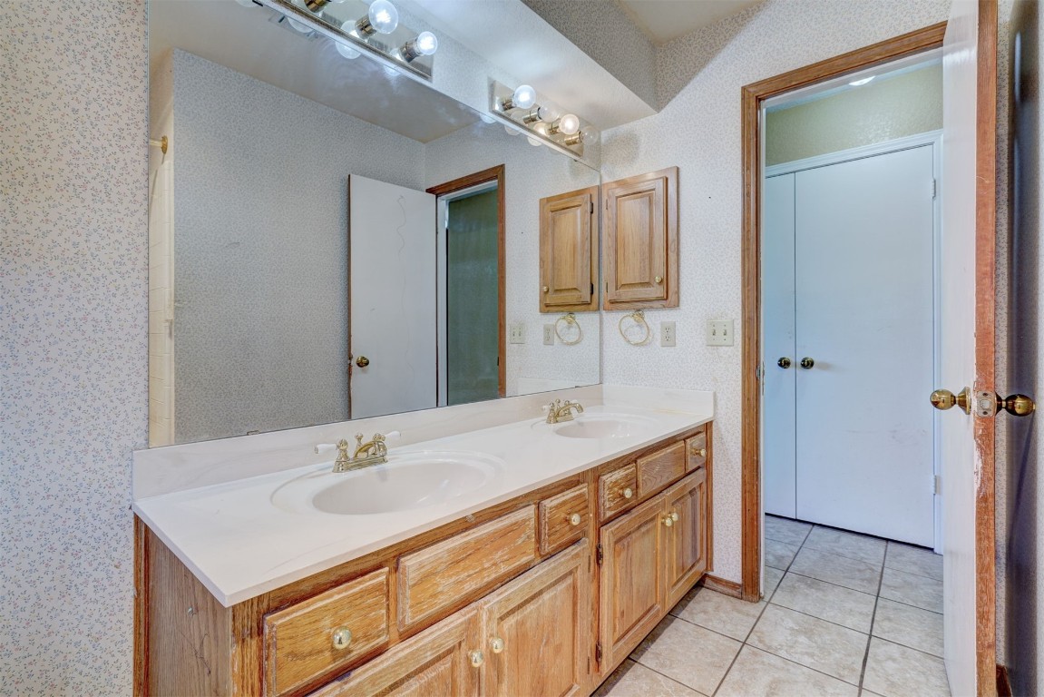 11440 Walters Avenue, Oklahoma City, OK 73162 bathroom featuring tile floors, dual sinks, and large vanity