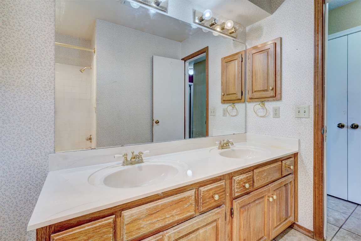 11440 Walters Avenue, Oklahoma City, OK 73162 bathroom featuring double sink, large vanity, and tile floors