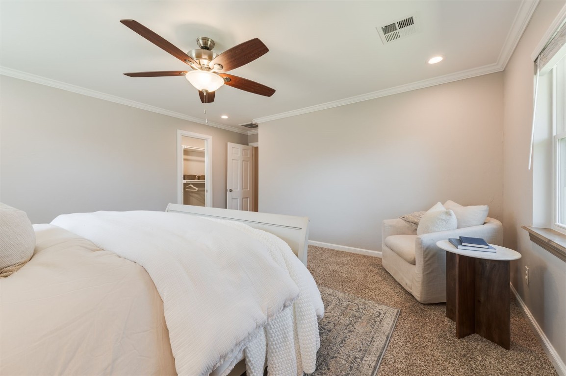 3108 Huntleigh Drive, Oklahoma City, OK 73120 bedroom with ceiling fan, light carpet, a closet, a spacious closet, and ornamental molding