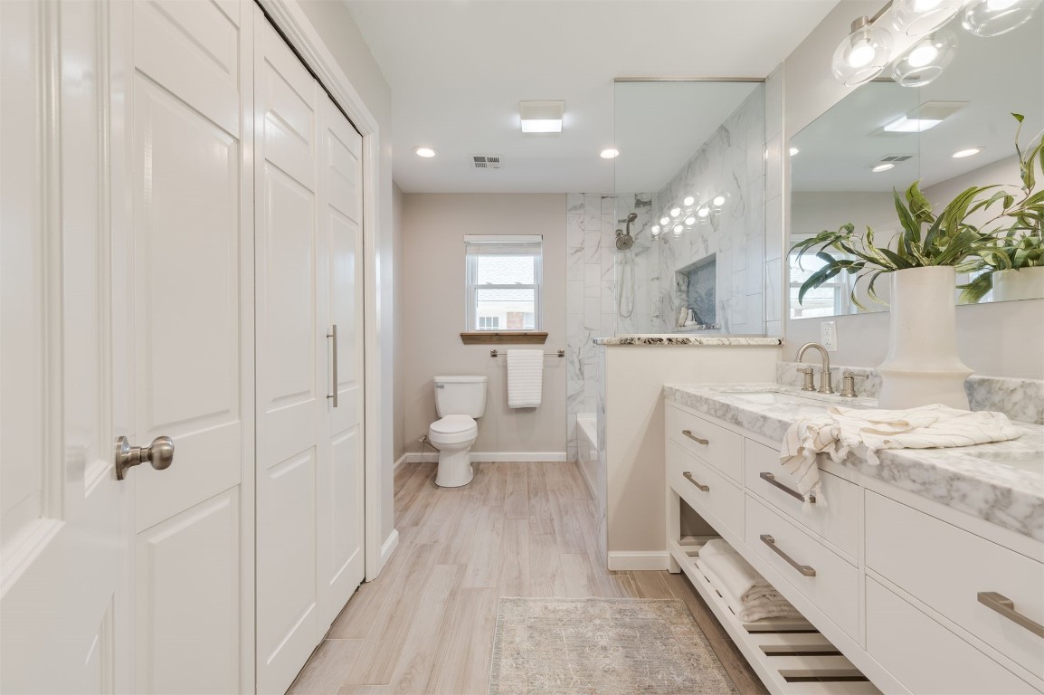 3108 Huntleigh Drive, Oklahoma City, OK 73120 bathroom featuring hardwood / wood-style flooring, vanity, and toilet
