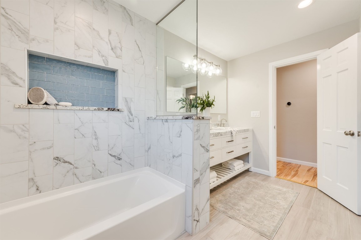 3108 Huntleigh Drive, Oklahoma City, OK 73120 bathroom featuring vanity, wood-type flooring, and tiled shower / bath combo