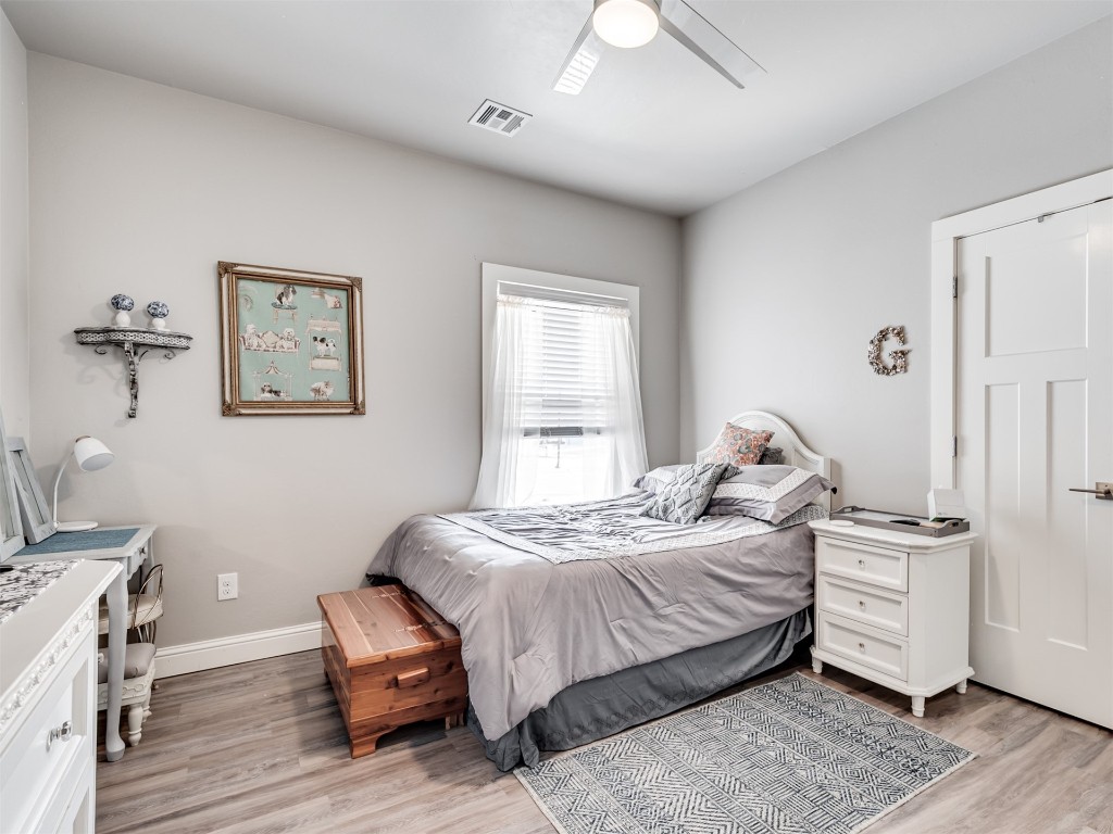 624 Frisco Ridge Road, Yukon, OK 73099 bedroom with light hardwood / wood-style flooring and ceiling fan