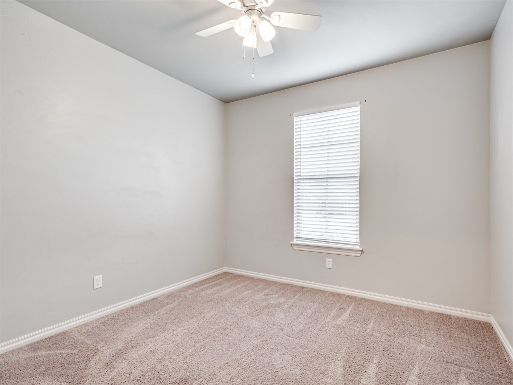 8208 NW 160th Terrace, Edmond, OK 73013 spare room featuring light carpet, a wealth of natural light, and ceiling fan