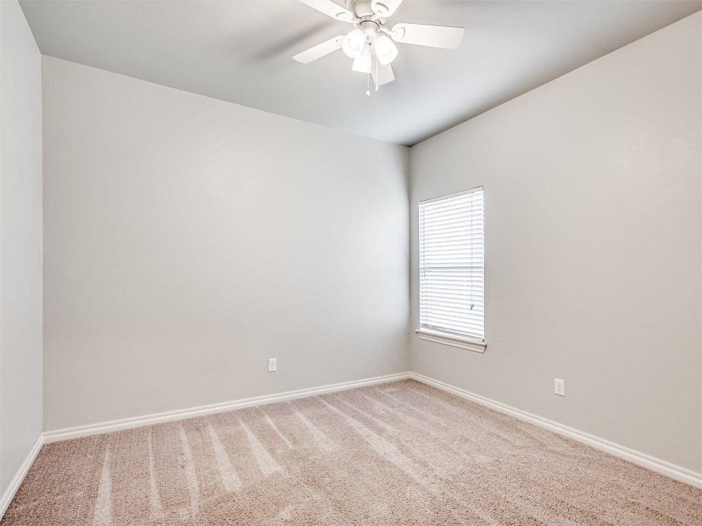 8208 NW 160th Terrace, Edmond, OK 73013 carpeted empty room featuring ceiling fan