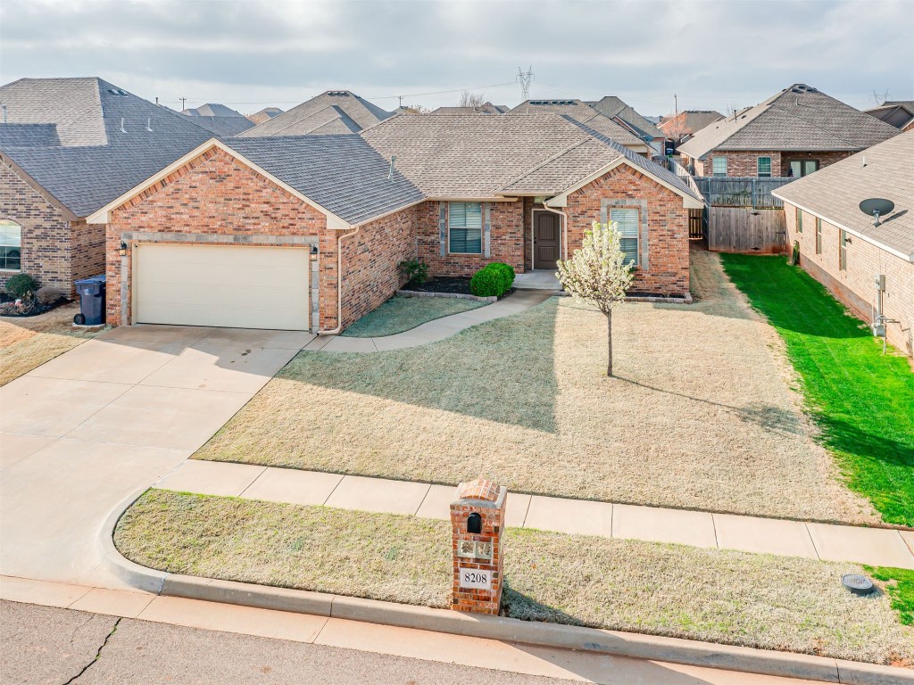 8208 NW 160th Terrace, Edmond, OK 73013 view of front of home with a garage and a front yard