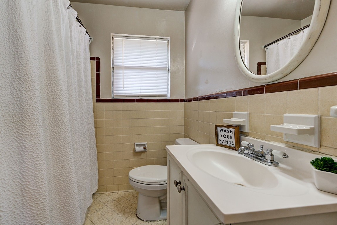 3022 NW 20th Street, Oklahoma City, OK 73107 bathroom featuring tile flooring, backsplash, tile walls, and vanity