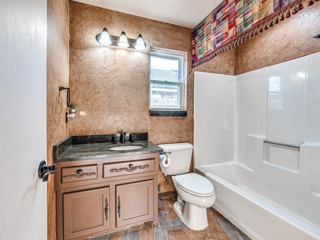 7616 NW 113th Street, Oklahoma City, OK 73162 full bathroom featuring vanity, toilet, tile flooring, and shower / bath combination