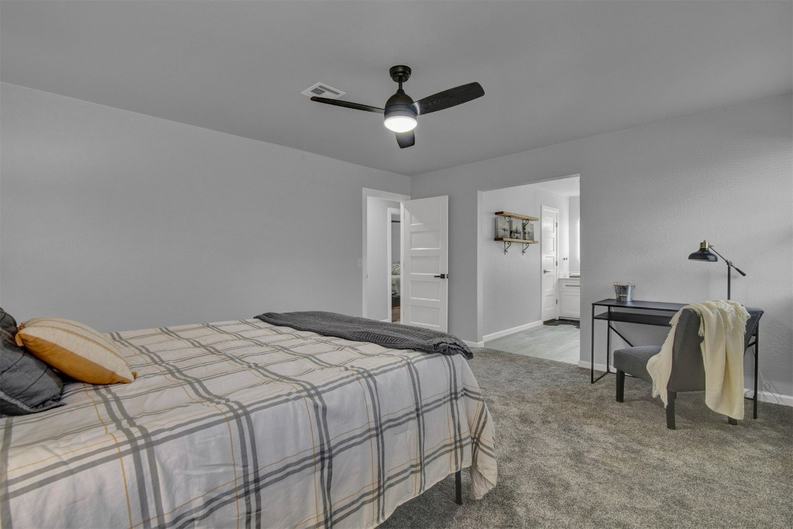 3012 Robin Road, Midwest City, OK 73110 carpeted bedroom featuring ensuite bath and ceiling fan