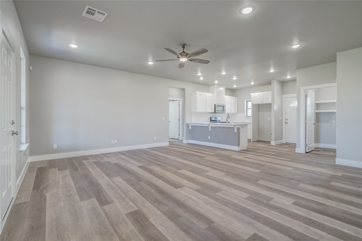 1525 NE 34th Street, Oklahoma City, OK 73111 unfurnished living room with ceiling fan and light hardwood / wood-style flooring