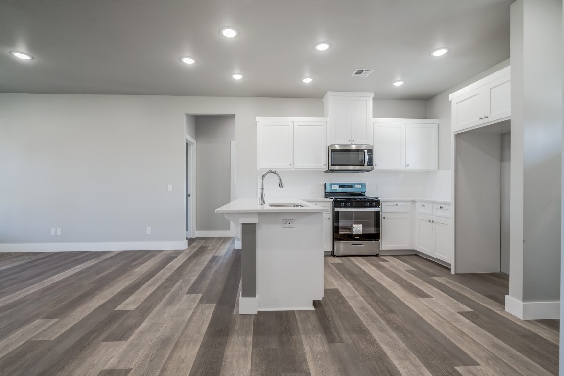 1525 NE 34th Street, Oklahoma City, OK 73111 kitchen featuring dark hardwood / wood-style floors, stainless steel appliances, white cabinets, and sink
